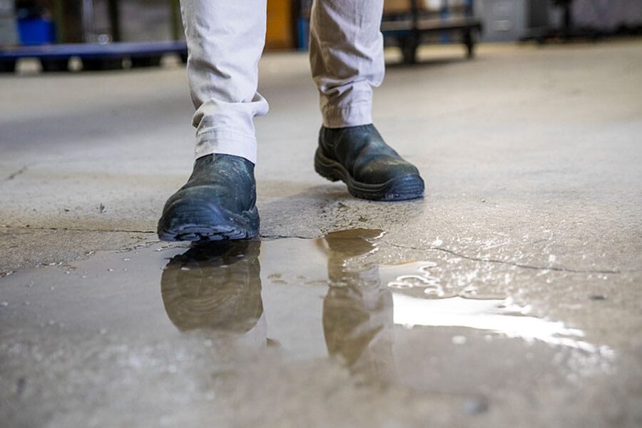 man about to slip on water on the floor in Houston, TX