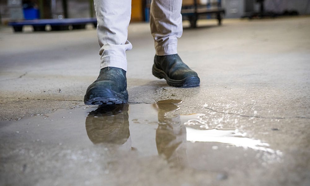 man about to slip on water on the floor in Houston, TX